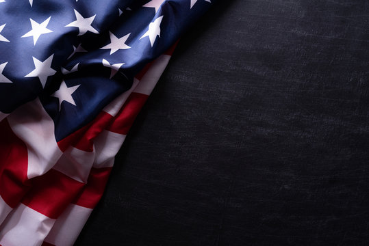 happy veterans day. american flags veterans against a blackboard background.
