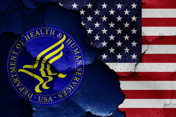 Wall Mural - flags of Department of Health and Human Services and USA painted on cracked wall
