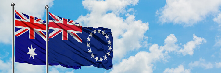 Australia and Cook Islands flag waving in the wind against white cloudy blue sky together. Diplomacy concept, international relations.