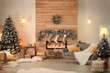 Stylish room interior with beautiful Christmas tree and decorative fireplace