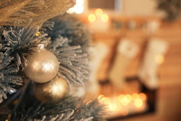 Beautiful decorated Christmas tree in festive room interior, closeup