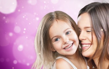 Wall Mural - Mother and Baby kissing and hugging at Home. Happy Smiling Family Portrait. Mom and Her Child Having Fun together