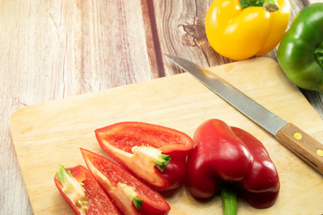 Wall Mural - Closeup  fresh  Red, Yellow, Green, bell pepper or sweet pepper or capsicum  isolate slice on  chopping wood on white background ,raw food ingredient concept.