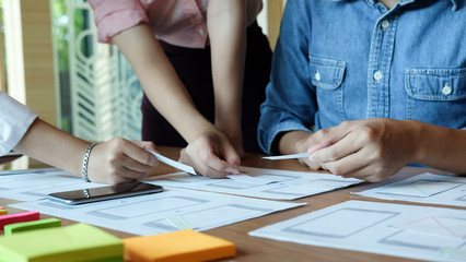 UX UI concept, Team of Website designer Creative planning development draft sketch drawing template layout on workplace.