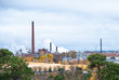 © Fox - Cityscape, red brick buildings of an old factory, factory chimneys smoke. Ecology problems in Europe.