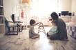 © natalialeb - happy mom with two children on the floor in room