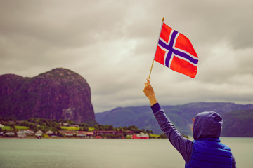 Poster - Tourist with norwegian flag on fjord