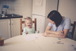 © natalialeb - mother with daughter write and draw at the table