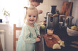 © natalialeb - siblings squeeze juice with an electric juicer