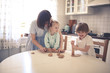 © natalialeb - funny kids siblings with mom cook in the kitchen