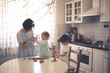 © natalialeb - funny kids siblings with mom cook in the kitchen
