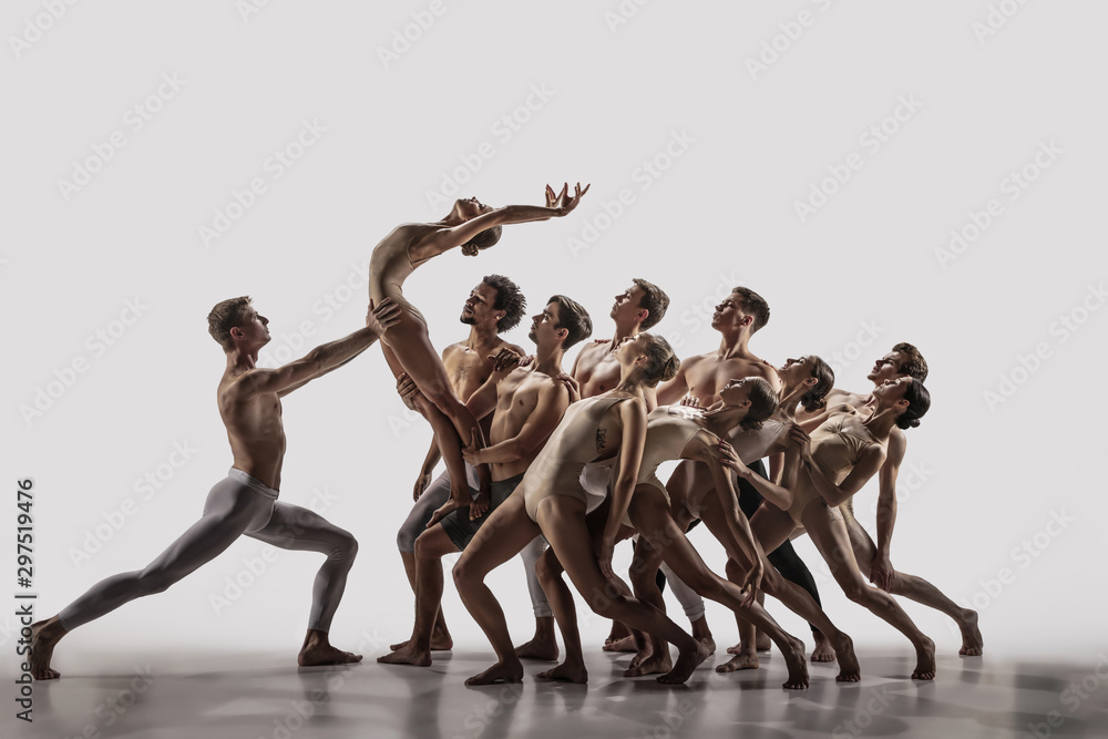 The group of modern ballet dancers. Contemporary art ballet. Young flexible athletic men and women in ballet tights. Studio shot isolated on white background. Negative space. - obrazy, fototapety, plakaty 