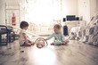 © natalialeb - boy and girl playing on floor with wooden rainbow