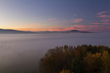 Fototapeta Natura - Aerial view to autumn misty fog, trees and hill in sunrise, Czech landscape