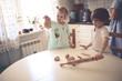 © natalialeb - boy and girl siblings are cooking together kitchen