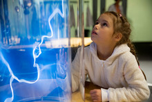 Finnish Science Center In Vantaa, Finland. Child Studying Electrical Discharges In A Lab.
