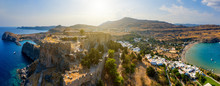 Breathtaking Panoramic Aerial View Of Lindos Town From The Acropolis Of Lindos In Rhodes, Greece. Amazing Colorful Sunset Scenery In Rhodes. Idyllic Background Above Aegean Sea. Dodecanese, Greece.