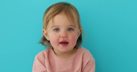 Wall Mural - Sweet baby girl closeup portrait of child isolated on blue background, cute toddler with blue eyes