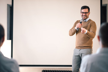 Business man giving presentation in a conference setting, copy space.