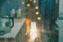 Water Drops On The Window Pane, Glass. Lights Of The City. Bokeh - Abstract Background. 