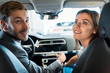 © LIGHTFIELD STUDIOS - selective focus of happy bearded man sitting in car with attractive woman