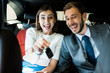 © LIGHTFIELD STUDIOS - selective focus of excited woman holding car key near handsome man in suit