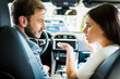 © LIGHTFIELD STUDIOS - selective focus of man and woman looking at each other in car