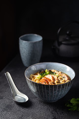 Wall Mural - japanese soup with fried eel Yanagawa Nabe in a bowl on dark background