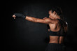 © Drobot Dean - Image of muscular african american woman boxing in hand wraps