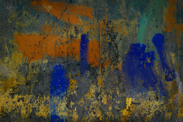 Abstract art texture background. Creative wall art close up. Beautiful dark background. Paint on the wall. Blue, grey, orange, green, yellow and golden old cracked concrete wall surface