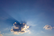 Ray Of Crepuscular Dazzling Sun Light Shine Through The Gap Among Cloud With Blue Sky For Design Purpose