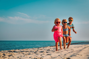 Poster - happy kids running on beach, boy and girls have fun at sea