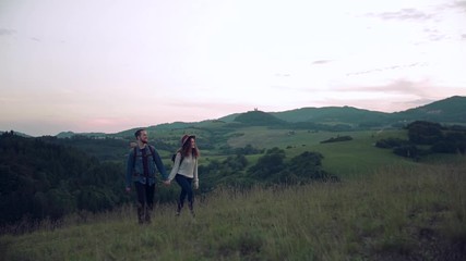 Wall Mural - young tourist couple travellers with backpacks hiking in nature.