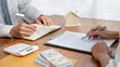 © MIND AND I - Real estate agent and customer signing contract to buy house, insurance or loan real estate.