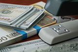 Fototapeta Miasta - The stapler fastens the dollar and euro notes with iron clips. Stapler with paper clips on the background of banknotes.