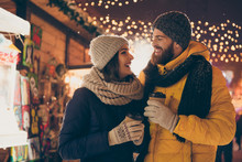 Photo Of Two People Cute Couple Husband Guy Wife Lady Drink Hot Beverage X-mas Eve Spend Time Magic Land Newyear Shopping Market Buying Gifts Wear Coats Outside