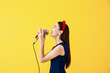 © Pixel-Shot - Beautiful young female singer with microphone on color background