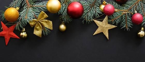 christmas decoration on black background  with fir tree branches and balls