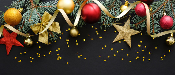 christmas decoration and fir tree branch on black background