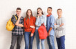 © Pixel-Shot - Portrait of teenagers near white brick wall