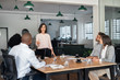 © mavoimages - Businesswoman meeting with her diverse team in an office