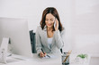 © LIGHTFIELD STUDIOS - smiling secretary talking on smartphone and writing in notebook while sitting at workplace