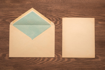 Sticker - Envelope and paper on a wooden background 