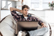 © ASDF - close up. tired guy dozing sitting in front of an open laptop