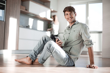 young man reading messages on his smartphone