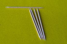Toothpicks On A Yellow Background Closeup