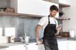 © ASDF - attractive young man standing near the kitchen table