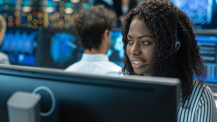 Aufkleber - Female Customer Service Representative Answer Client's Questions in a Headset. She Works for a Big Technological Company. Office Has Multi-Ethnic Team of Specialists, Displays Show Useful Infographics