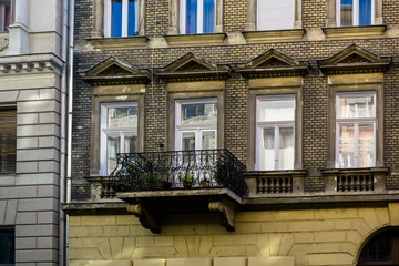 History or architecture background featuring details of gloomy dark facades of historical vintage buildings waiting renovation in downtown Budapest, Hungary. 