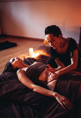 Wall Mural - Sensual massage with essential oils is performed in a woman's massage salon